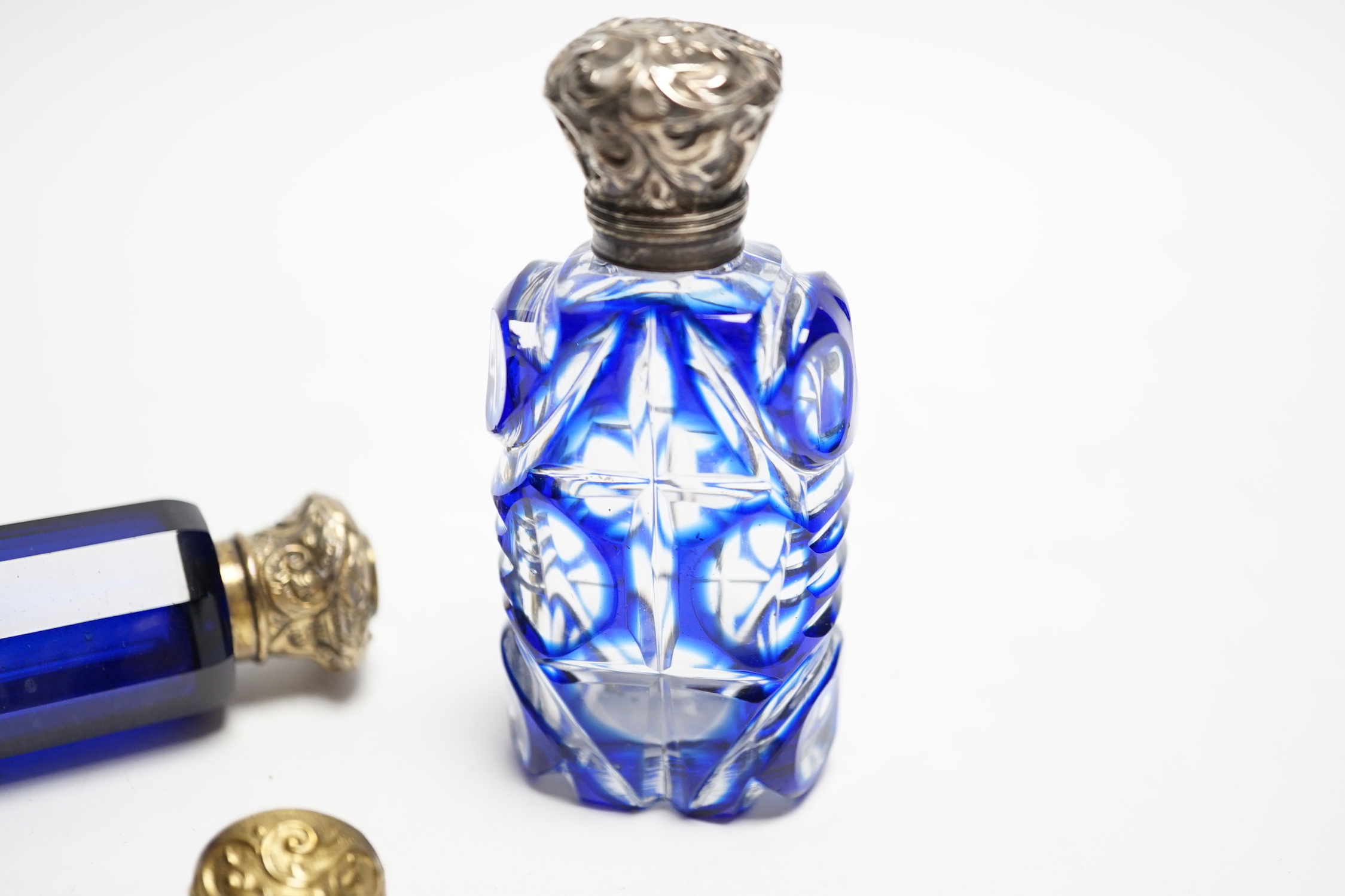 Four assorted Victorian white or gilt metal mounted cut glass scent bottles, including double ended blue glass scent bottle, 12.2cm.